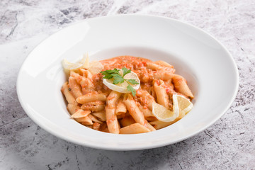 tasty penne with tuna pasta on white plate