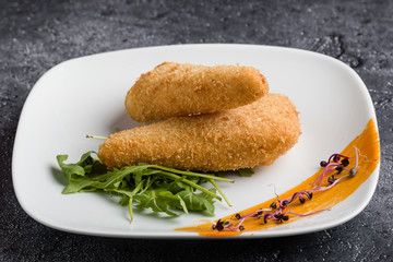 tasty fresh fried breaded cheese on white palte