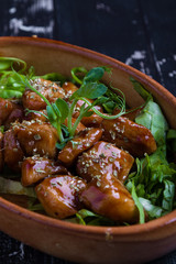 small tasty fresh chicken bites in a rustic bowl