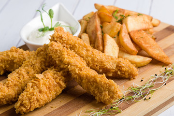 deep fried crispy chicken with fries and dipping sauce