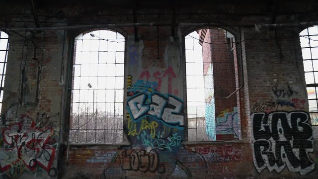 Old, abandoned and closed industrial factory building painted with graffiti