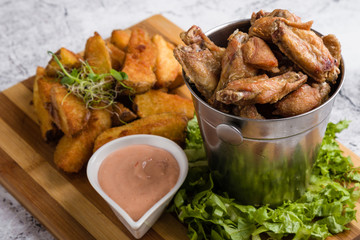 fried chicken wings with potato and dipping sauce