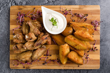 fried chicken wings with potato and dipping sauce