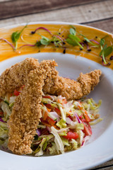 tasty crispy chicken salad appetizer in white plate