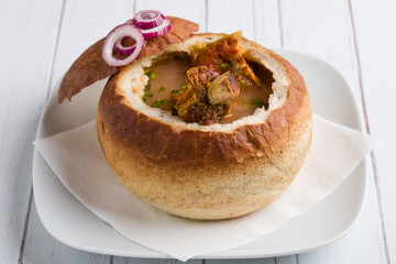 tasty delicious bean soup with smoked meat in bread