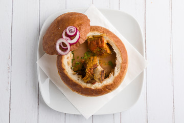 tasty delicious bean soup with smoked meat in bread