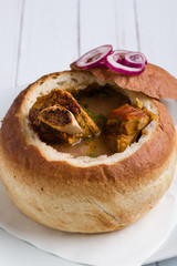 tasty delicious bean soup with smoked meat in bread