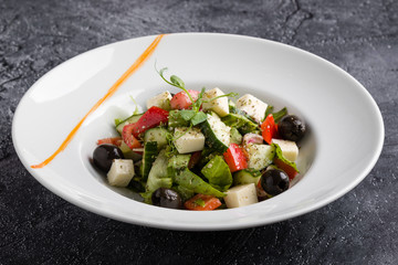 fresh tasty greek salad appetizer on white plate