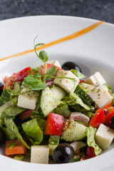 fresh tasty greek salad appetizer on white plate