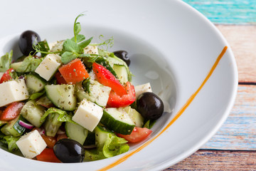fresh tasty greek salad appetizer on white plate
