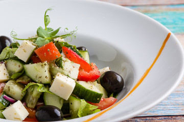 fresh tasty greek salad appetizer on white plate