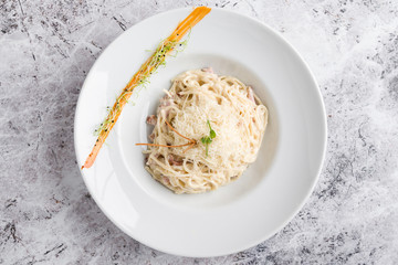 italian spahetti carbonara pasta in white plate