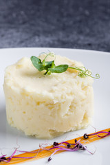 fresh mashed potato portion on white plate