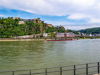 Obraz premium View of the Rhine River with a cargo ship, Phillipsburg Palace, Ehrenbreitstein Fortress and the aerial tramway