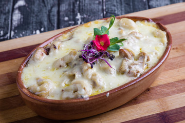tasty delicious baked tortellini pasta in rustic bowl