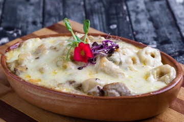 tasty delicious baked tortellini pasta in rustic bowl