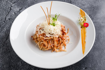 italian spaghetti amatriciana pasta on white plate