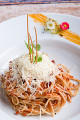 italian spaghetti amatriciana pasta on white plate