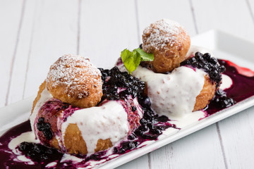 fresh delicious cottage cheese donuts with jam on white plate