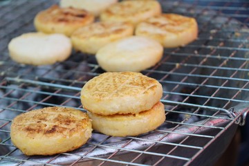 Grilled sticky rice with egg plating on stove