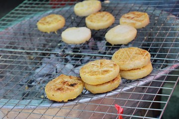 Grilled sticky rice with egg plating on stove
