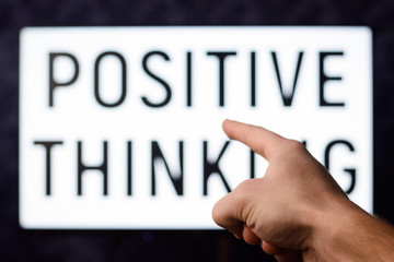 Male pointing to a screen with inscription POSITIVE THINKING. Symbol of belief in success