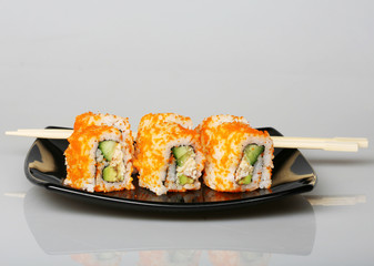 japanese  rolls on black plate.