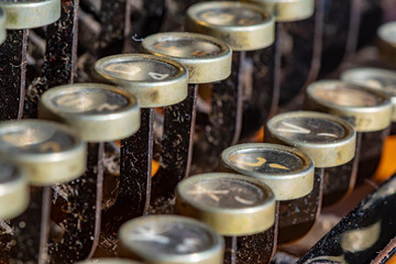Detail of a historic dusty portable typewriter made in Germany during the twenties of the 20th century.