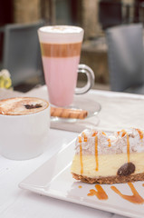 cup of coffee and cake on wooden table