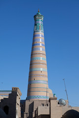 Ancient minaret on the street of the old city. Uzbekistan. Khiva...