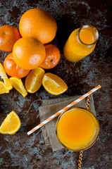 Fototapeta na wymiar orange juice in a glass and pieces