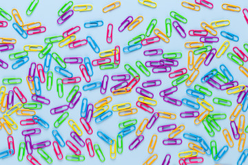 Paper color clip notebook on blue background. Flat lay.