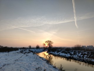 sunset over frozen river