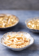 Coenzyme Q10, Omega 3 and Vitamin E capsules. Dietary supplements. Rustic wooden background. Close up. 
