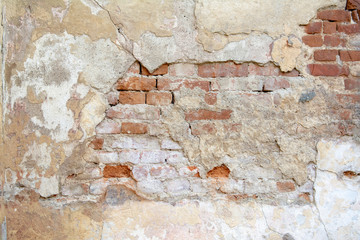 Fototapeta premium red brick wall with old falling plaster. Background.
