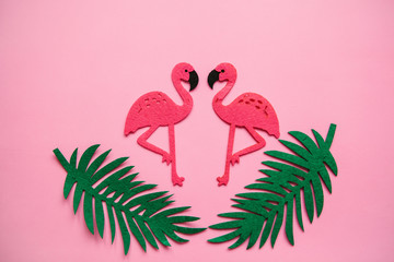 Flamingos and leaves on a pink background. Summer design.