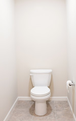 Fototapeta na wymiar American White Toilet with Tan Tiled Floor