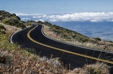 Maui Mountain Road:  The road from the top of Mt. Haleakalā begins above the clouds and descends...