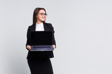 Gorgeous woman holding black laptop on white background. Business concept!