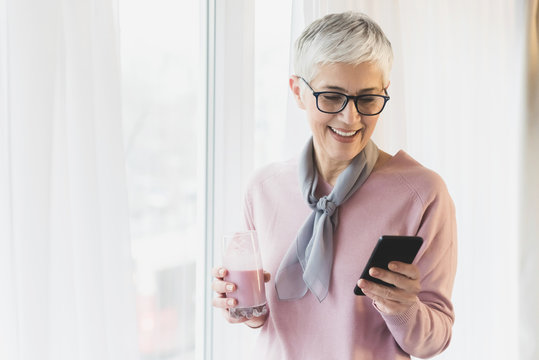 Mature Woman Texting On The Mobile Phone