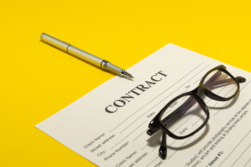 The contract for the yellow table and pen.