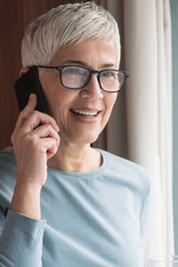 Fototapeta premium Senior woman talking on her phone