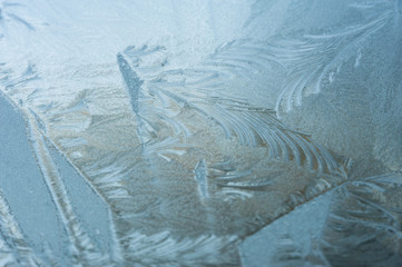 Close up of abstract patterns of ice forming on a frozen windshield