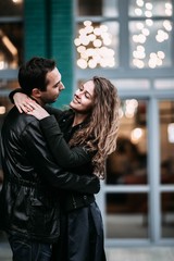 beautiful couple in love walks and dances in the evening city. Romantic date