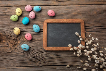 Quails eggs in nest and flowers. Easter greeting card. Top view with space for your greetings