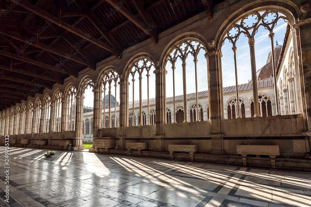 Wall mural windows at sunny day at the 13th century camposanto monumentale, ancient cemetery of tuscany. histor