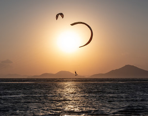 sunset paragliding show on the beach