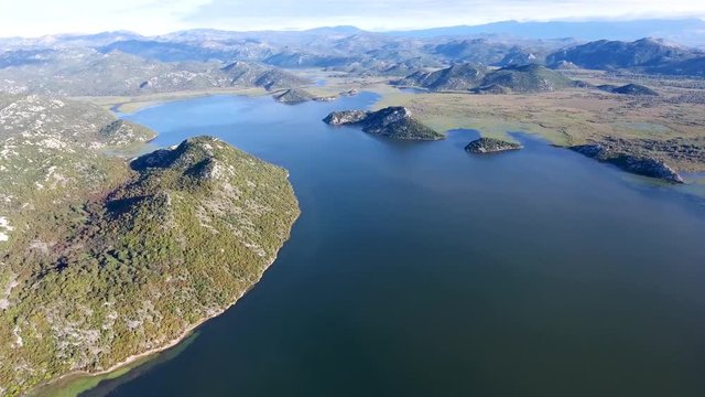 Skadar Lake with a bird's-eye view. Drone from a height removes the western part of the lake. See the bridge and the mountains in the green.