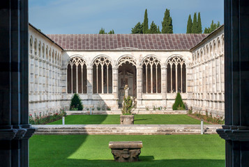 Courtyard with grass at the 13th century Camposanto Monumentale, ancient cemetery of Tuscany....