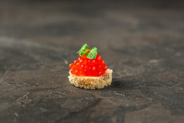 red caviar (canape or sandwich with red snack) salmon fish, seafood. food background. top view